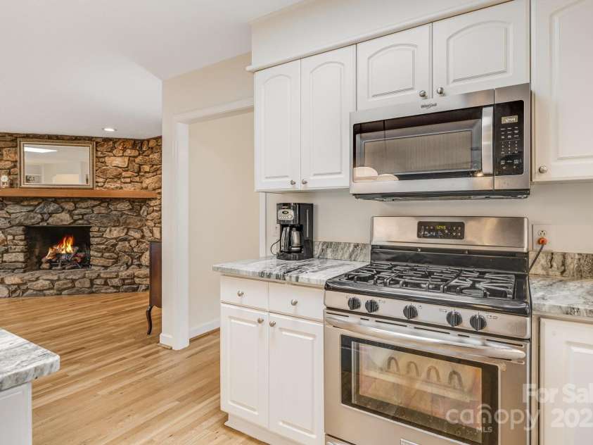 53 Jump Cove Road, Weaverville, NC 28787.  MLS# CAR4209397, YatesRealty ID 12056. Kitchen Opens to Fire Room