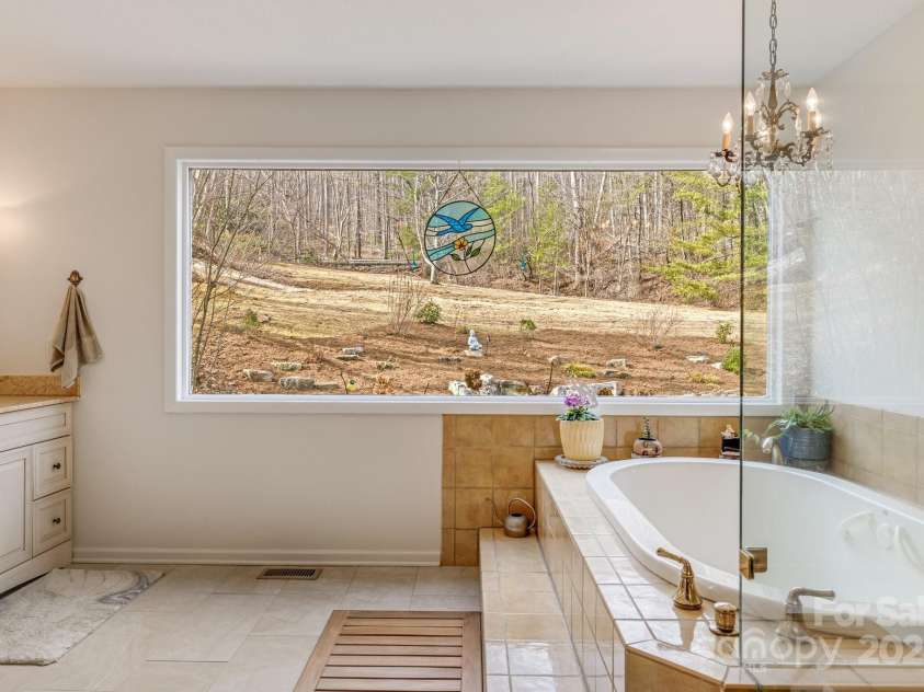 53 Jump Cove Road, Weaverville, NC 28787.  MLS# CAR4209397, YatesRealty ID 12056. Luxurious Primary Suite Overlooking Back Yard