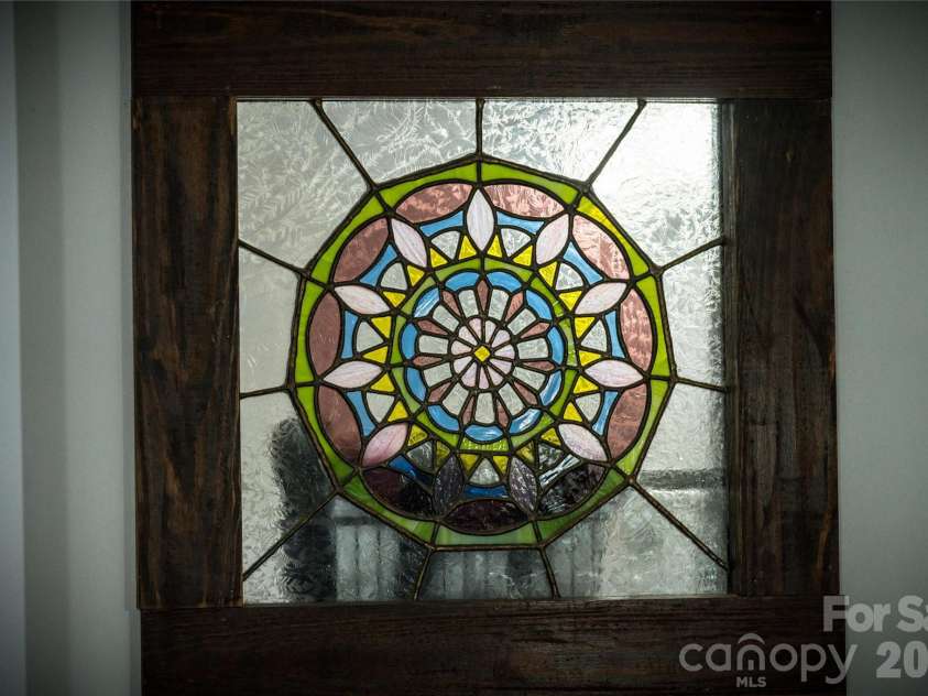 125 Timberline Drive, Maggie Valley, NC 28751.  MLS# CAR4365307, YatesRealty ID 12058. Charming stain glass accents