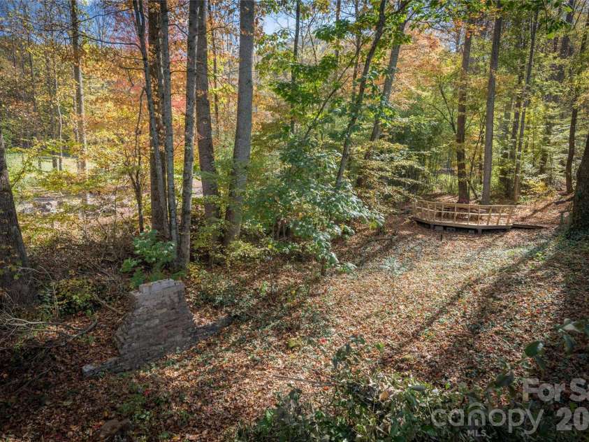 125 Timberline Drive, Maggie Valley, NC 28751.  MLS# CAR4365307, YatesRealty ID 12058. Creekside deck setting in the woods