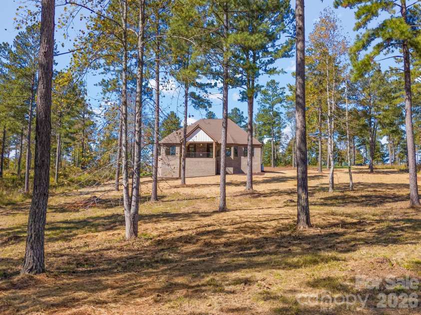 2024 Jumping Run, Connelly Springs, NC 28612.  MLS# CAR4336928, YatesRealty ID 1206. Wooded backyard
