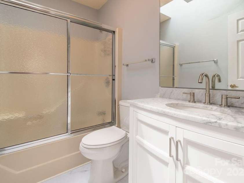 124 Exeter Court, Hendersonville, NC 28791.  MLS# CAR4159638, YatesRealty ID 12066. Bathroom has new tile flooring and new Vanity