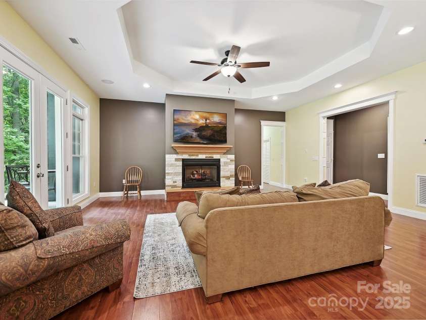 1140 Fern Hill Road, Mooresville, NC 28117.  MLS# CAR4255290, YatesRealty ID 12085. Basement great room with fireplace hardwood floors, part of separate livng area includes kitchen and separate bedroom.