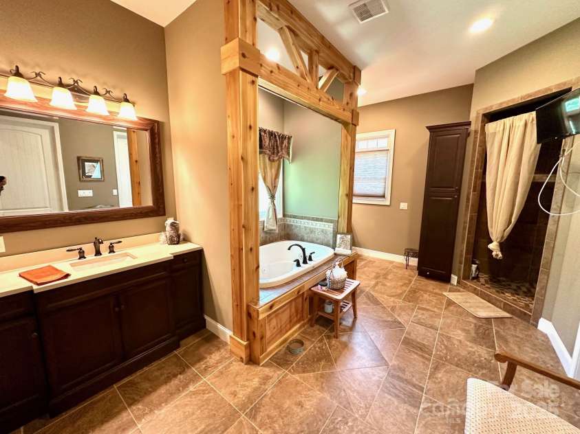 1140 Fern Hill Road, Mooresville, NC 28117.  MLS# CAR4255290, YatesRealty ID 12085. Elegant primary bath with his and her closets, whirlpool tub, sep shower.