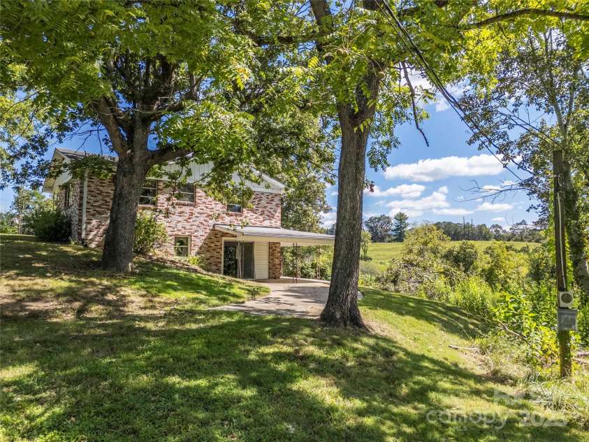 56 Gill Branch Road, Weaverville, NC 28787.  MLS# CAR4270678, YatesRealty ID 1209. Side of house with 2nd entrance and lower covered porch