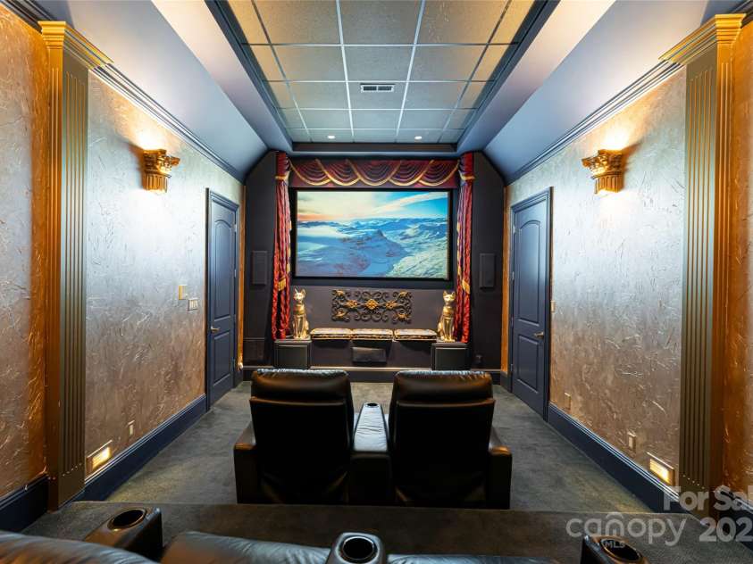 2005 Viburnum Lane, Asheville, NC 28803.  MLS# CAR4151623, YatesRealty ID 12090. Custom Home Theatre accented, themed, uplighting, floor lighting and enchanting ceiling lighting.