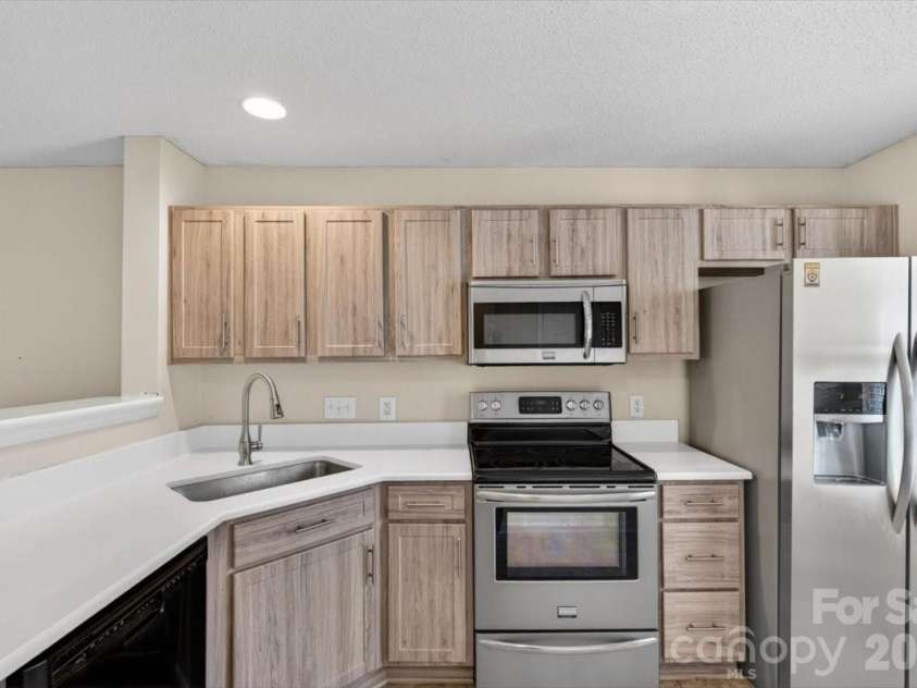 17035 Turning Stick Court, Charlotte, NC 28213.  MLS# CAR4370469, YatesRealty ID 12098. The updated kitchen includes the refrigerator too.