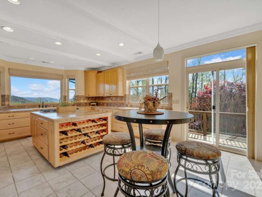 246 Pinnacle Mountain Road, Zirconia, NC 28790.  MLS# CAR4249618, YatesRealty ID 12104. Chef's kitchen with more picture windows showcasing the fabulous views