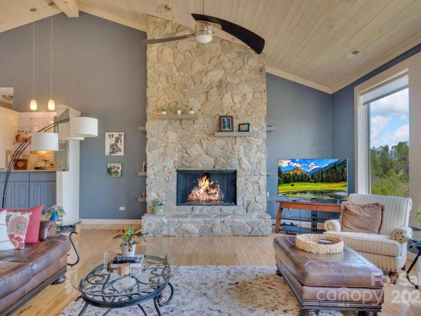 246 Pinnacle Mountain Road, Zirconia, NC 28790.  MLS# CAR4249618, YatesRealty ID 12104. Gorgeous stone fireplace, vaulted wood ceilings, wet bar to left of the fireplace