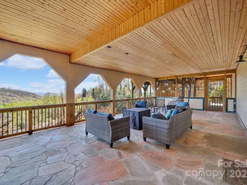 246 Pinnacle Mountain Road, Zirconia, NC 28790.  MLS# CAR4249618, YatesRealty ID 12104. Large covered entertainment space accessed from the lower level with beautiful stone patio