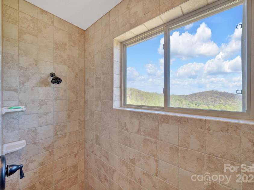 246 Pinnacle Mountain Road, Zirconia, NC 28790.  MLS# CAR4249618, YatesRealty ID 12104. Spacious walk-in tiled shower and yes even views from your shower!