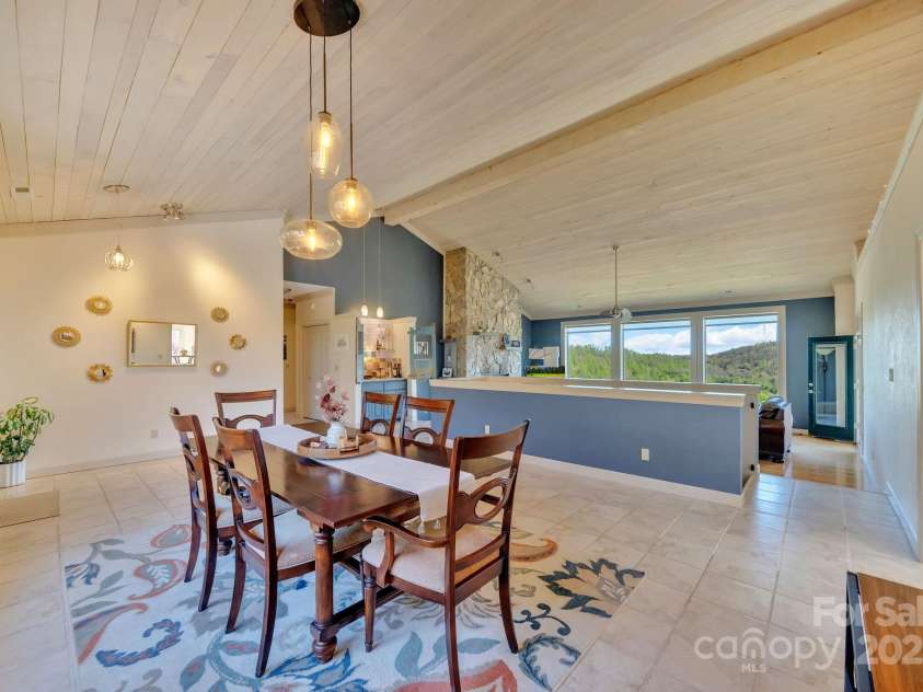 246 Pinnacle Mountain Road, Zirconia, NC 28790.  MLS# CAR4249618, YatesRealty ID 12104. View from front of the home looking into dining and living rooms.  You'll always capture the views!