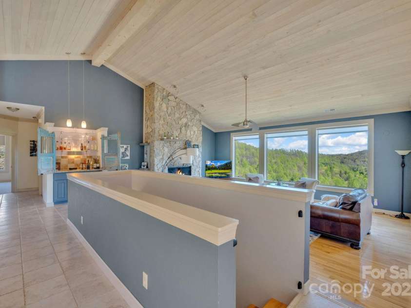 246 Pinnacle Mountain Road, Zirconia, NC 28790.  MLS# CAR4249618, YatesRealty ID 12104. View from kitchen into living room, staircase shown