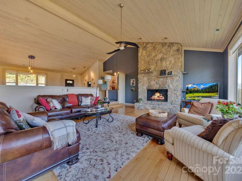 246 Pinnacle Mountain Road, Zirconia, NC 28790.  MLS# CAR4249618, YatesRealty ID 12104. View in spacious living room looking toward the front door, open floor plan to dining room.  Lots of windows and light and 24/7 views!