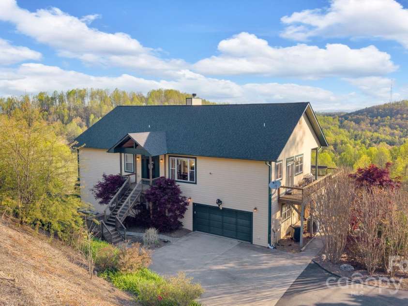 246 Pinnacle Mountain Road, Zirconia, NC 28790.  MLS# CAR4249618, YatesRealty ID 12104. View of the front of the home, garage and covered front porch, new roof Oct/2024