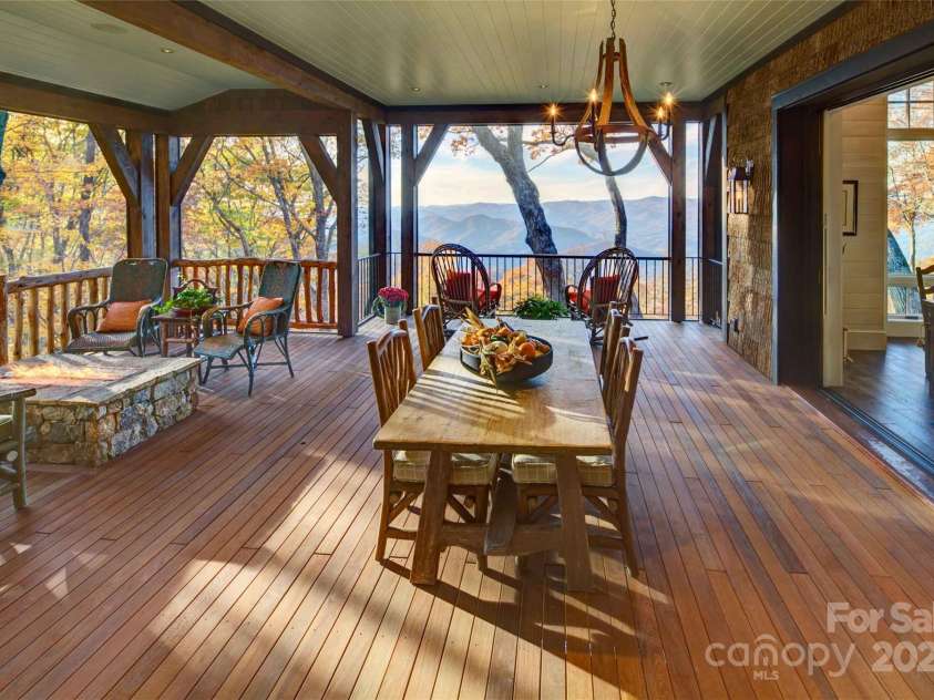 616 Old Growth Forest Road, Burnsville, NC 28714.  MLS# CAR4076276, YatesRealty ID 12106. A deck with great outdoor living - notice the welcoming firepit on the left~