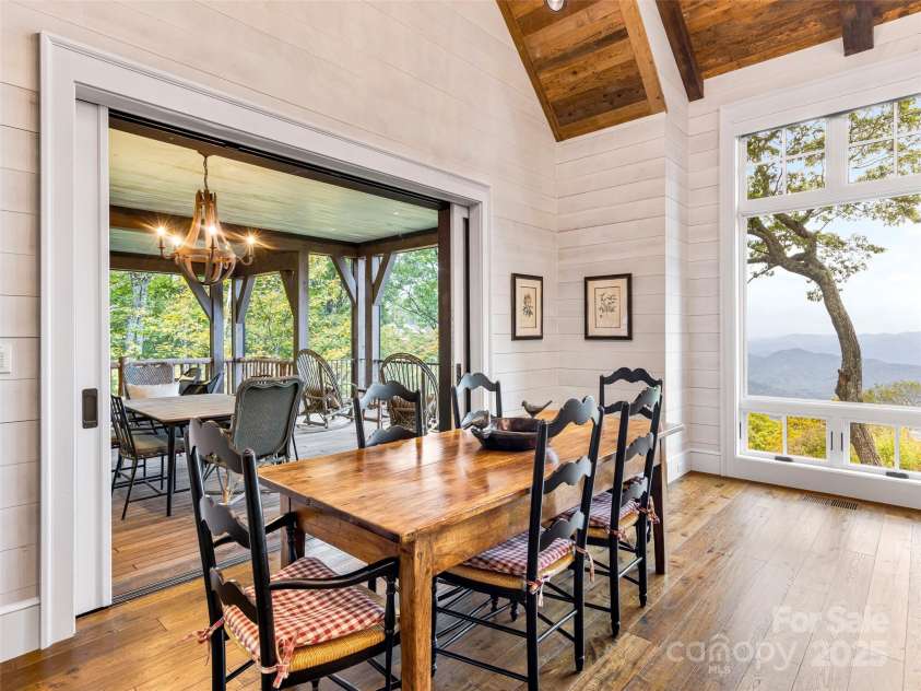 616 Old Growth Forest Road, Burnsville, NC 28714.  MLS# CAR4076276, YatesRealty ID 12106. Your dining area (with views) encircled by shiplap walls and access to screen deck
