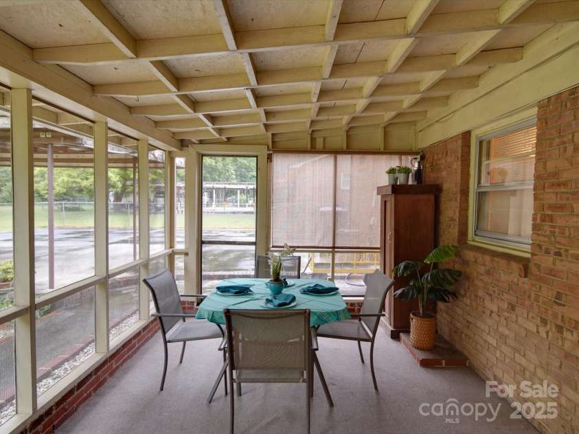2213 Milton Road, Charlotte, NC 28215.  MLS# CAR4255190, YatesRealty ID 12108. Lots of seating in this cozy covered porch off the den