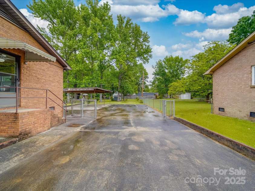 2213 Milton Road, Charlotte, NC 28215.  MLS# CAR4255190, YatesRealty ID 12108. Pictures show the gated driveway both opened and closed