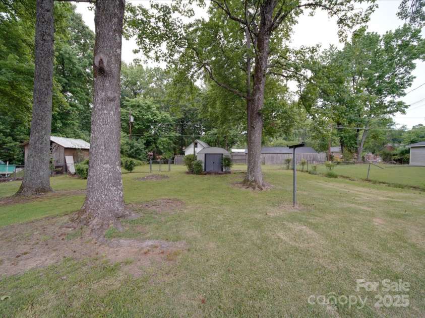 2213 Milton Road, Charlotte, NC 28215.  MLS# CAR4255190, YatesRealty ID 12108. The yard goes all the way beyond the metal fence to the privacy fence behind
