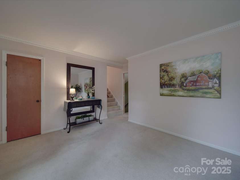 2213 Milton Road, Charlotte, NC 28215.  MLS# CAR4255190, YatesRealty ID 12108. View from living room toward steps to upper bedrooms