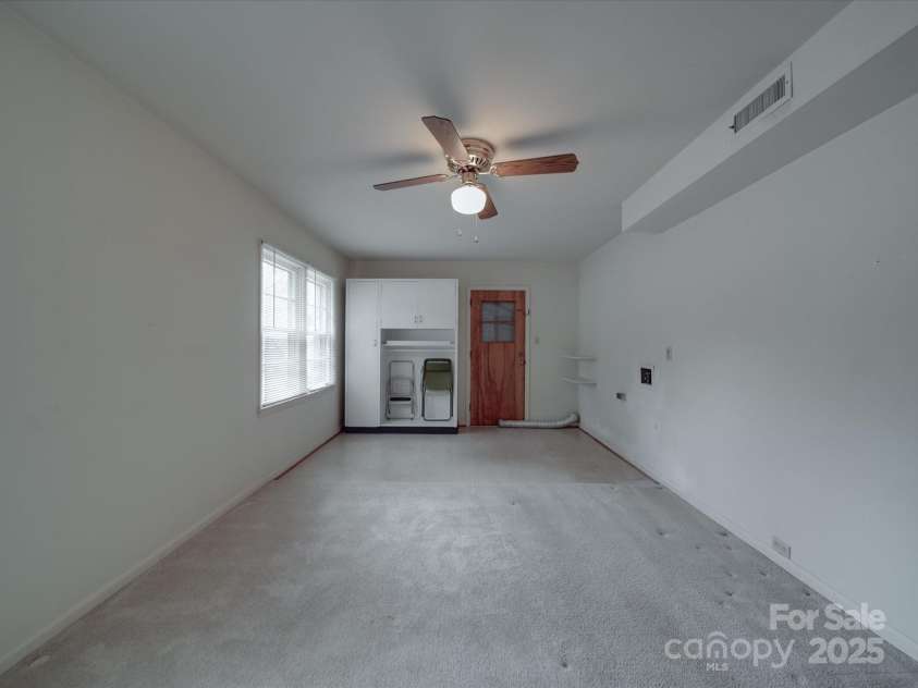 2213 Milton Road, Charlotte, NC 28215.  MLS# CAR4255190, YatesRealty ID 12108. View of deep fourth bedroom toward side entry that could become a primary patio entry, here showing the laundry hookups that would allow access to plumbing for adding another full bath