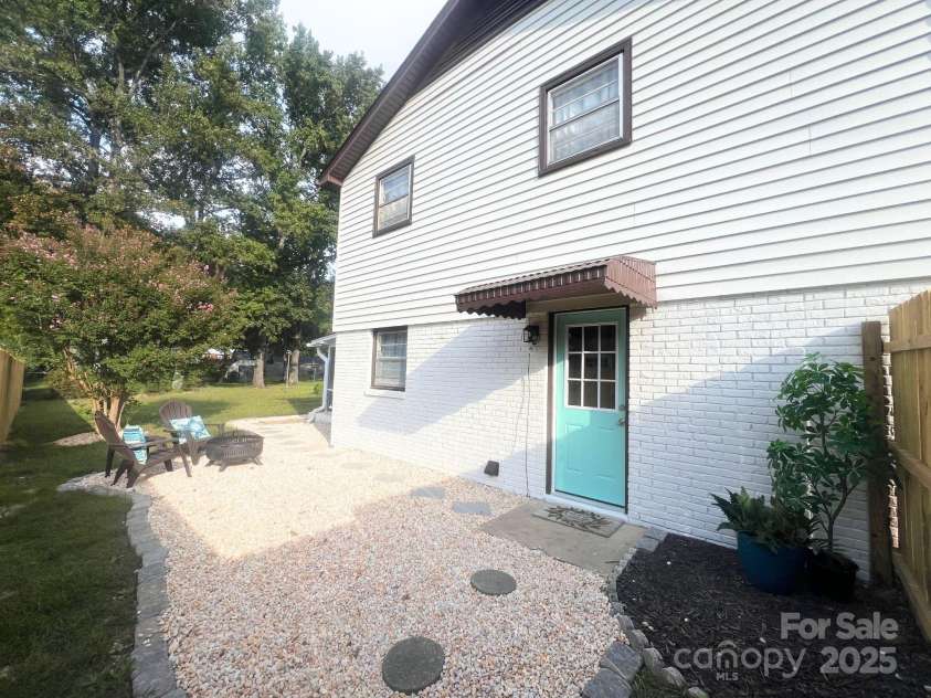 2213 Milton Road, Charlotte, NC 28215.  MLS# CAR4326281, YatesRealty ID 12108. A courtyard off the family room is staged with a firepit and totally private!