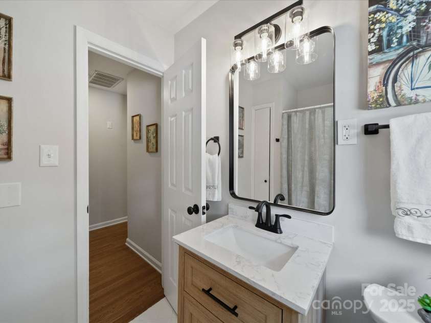2213 Milton Road, Charlotte, NC 28215.  MLS# CAR4326281, YatesRealty ID 12108. New vanity, mirror, and lighting in common bath