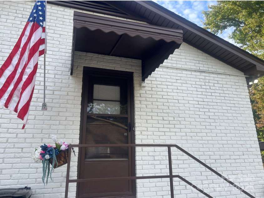 2213 Milton Road, Charlotte, NC 28215.  MLS# CAR4326281, YatesRealty ID 12108. Outdoor porches are coved with awnings.