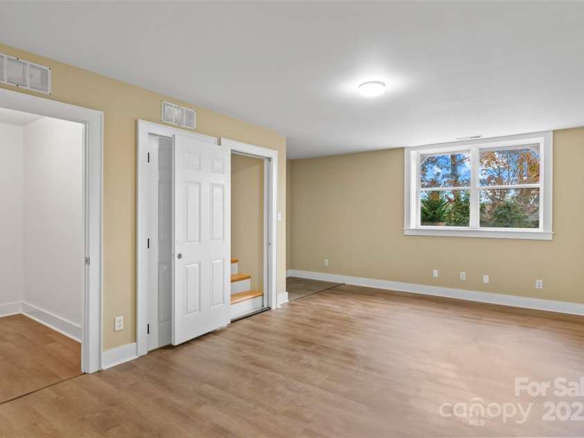 5 Elmore Street, Asheville, NC 28804.  MLS# CAR4252393, YatesRealty ID 12118. Bright finished basement with private entrance and large window.