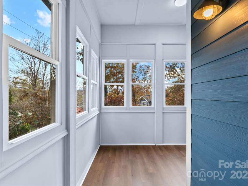 5 Elmore Street, Asheville, NC 28804.  MLS# CAR4252393, YatesRealty ID 12118. Sunroom perfect for growing plants or a cozy sitting area