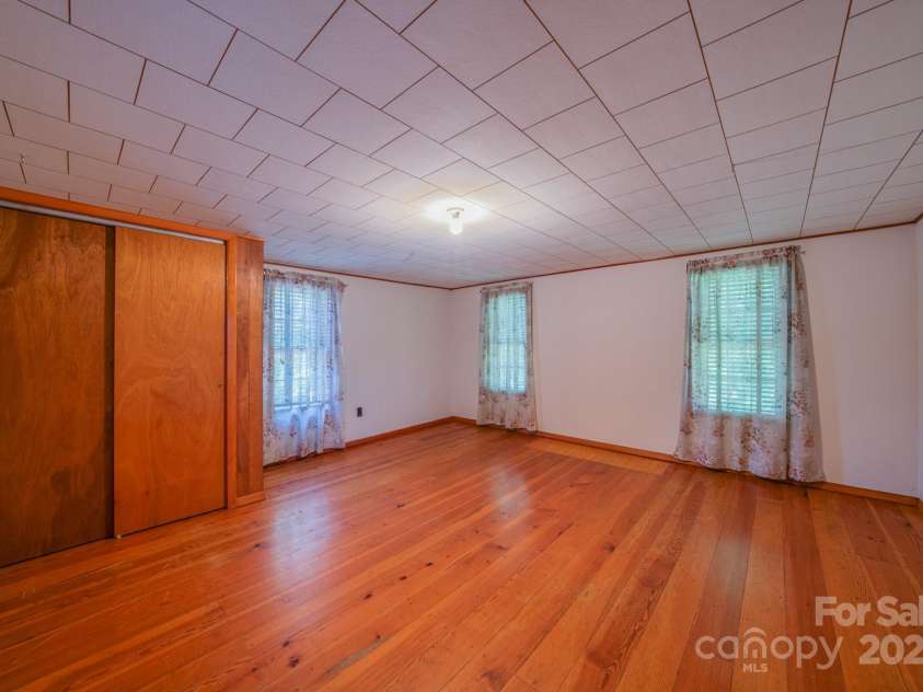 502 and  504 Old US 19 23 Highway, Candler, NC 28715.  MLS# CAR4164132, YatesRealty ID 12166. Upstair bedroom on left