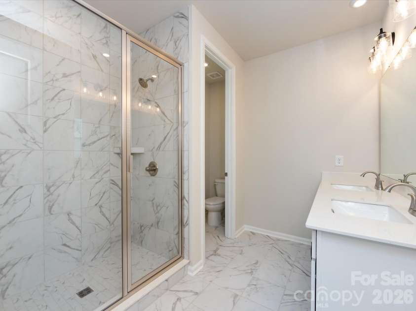 2108 Endeavor Run, Charlotte, NC 28269.  MLS# CAR4318966, YatesRealty ID 12171. Primary En Suite Bath with Modern Tile Design and Walk-In Shower. 