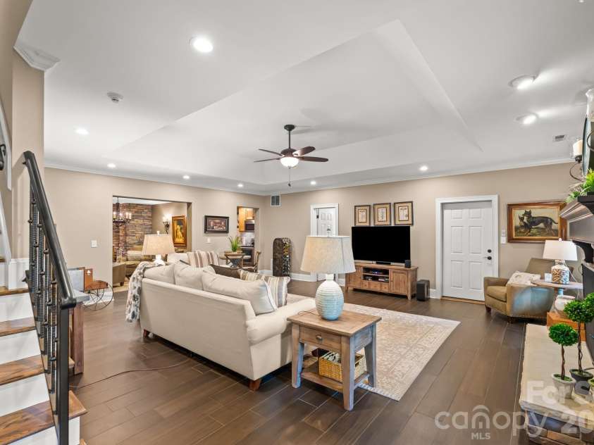 11555 Double Spring Road, Lewisville, NC 27023.  MLS# CAR4370300, YatesRealty ID 12175. Luxurious lower level with stone fireplace, gas logs, extensive storage, kitchen, wine cellar, and garage bay.
