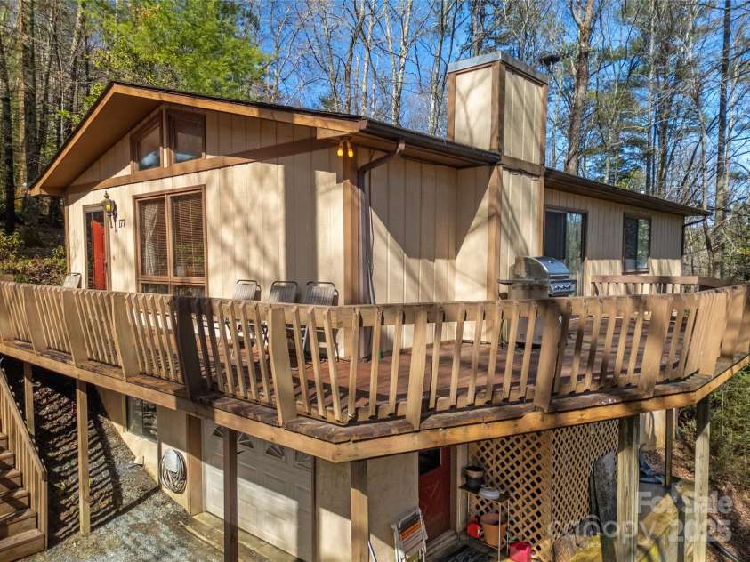 177 Walelu Court, Brevard, NC 28712.  MLS# CAR4333562, YatesRealty ID 1218. Wrap around deck either to greet your visitors or retreat within the trees.