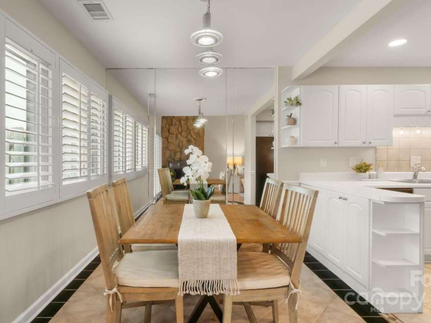 8326 Ramath Drive, Charlotte, NC 28211.  MLS# CAR4250067, YatesRealty ID 12182. Dining area with wall of windows and mirrored wall reflects more light