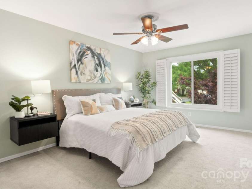8326 Ramath Drive, Charlotte, NC 28211.  MLS# CAR4250067, YatesRealty ID 12182. Primary suite with fresh neutral paint, built in floating nightstands, Bahama shutters, and mounted TV.