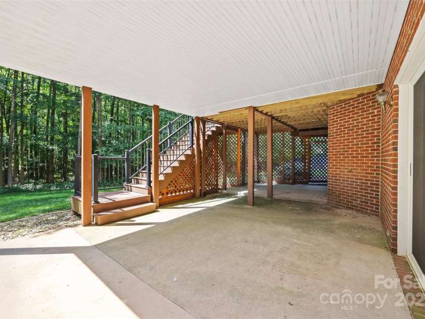 7103 Forest Ridge Road, Matthews, NC 28104.  MLS# CAR4255751, YatesRealty ID 12216. Covered patio from walk- out basement