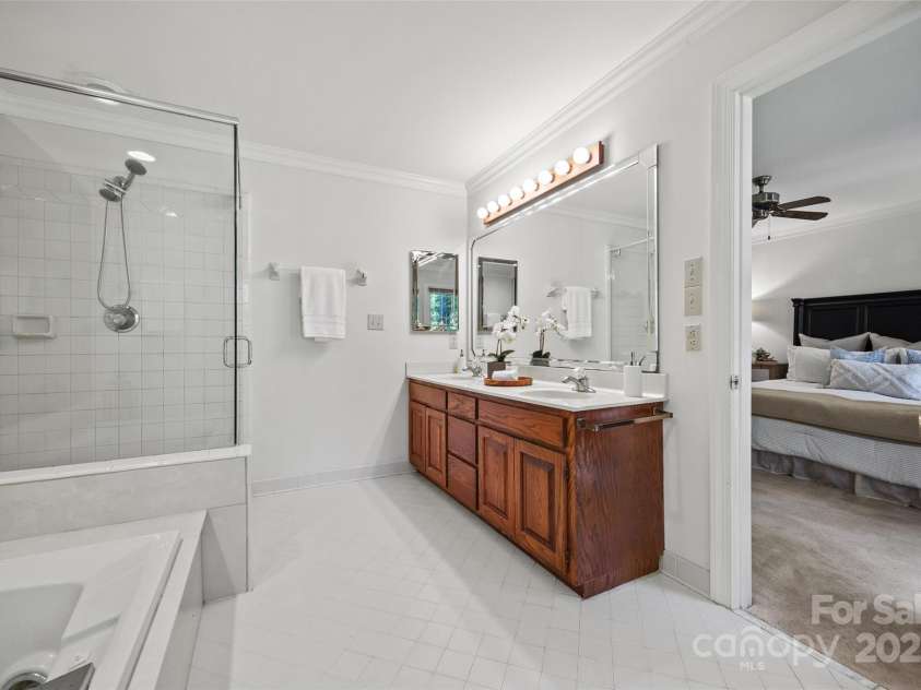 7103 Forest Ridge Road, Matthews, NC 28104.  MLS# CAR4255751, YatesRealty ID 12216. Primary bath, large glass shower, dual vanity and tub