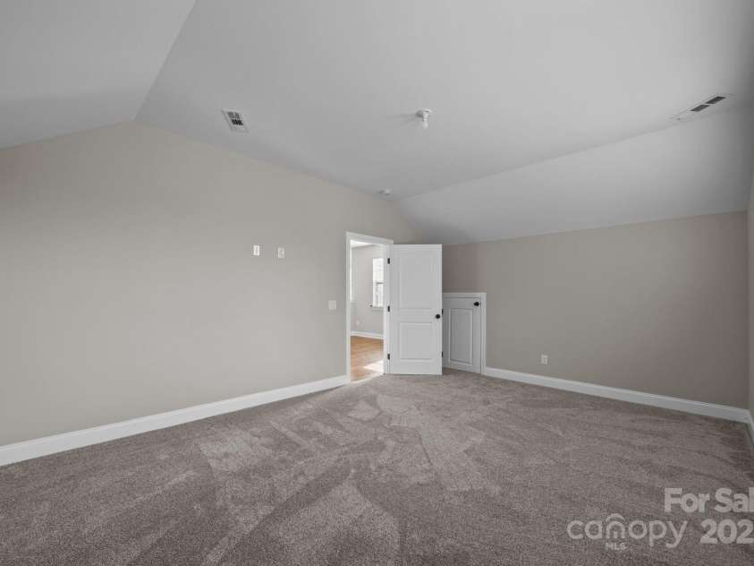 11304 Preservation Lane, Charlotte, NC 28278.  MLS# CAR4249820, YatesRealty ID 12218. Bonus room with brand new carpet and small door access to attic storage.