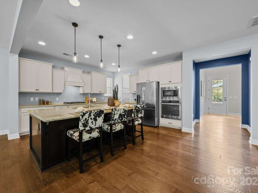 11304 Preservation Lane, Charlotte, NC 28278.  MLS# CAR4249820, YatesRealty ID 12218. The gourmet kitchen features an oversized island with seating for three, modern pendant lighting and upgraded cabinetry!