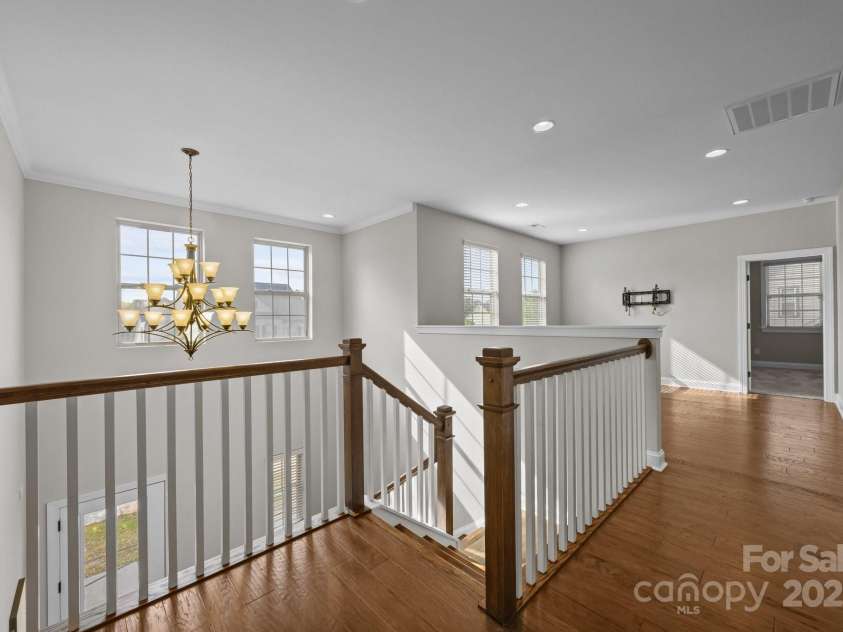 11304 Preservation Lane, Charlotte, NC 28278.  MLS# CAR4249820, YatesRealty ID 12218. Upstairs hall and loft area with hardwood floors, recessed lighting and wall mount for a TV