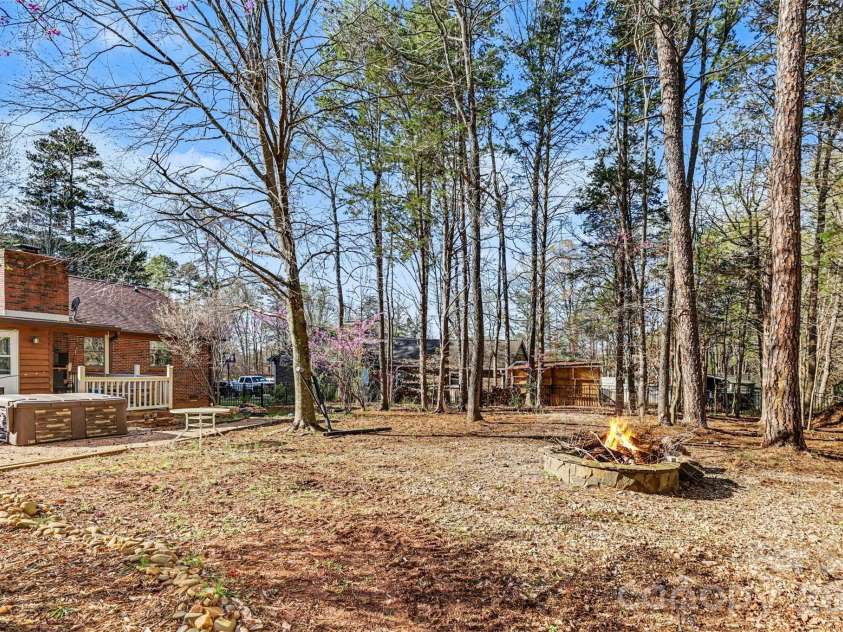 2199 Coddle Creek Highway, Mooresville, NC 28115.  MLS# CAR4359569, YatesRealty ID 12235. Back Yard with Hot Tub, Deck, and Fire Pit