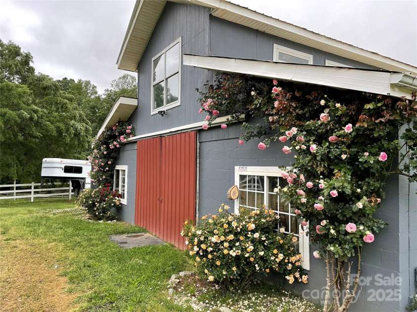228 Red Dog Drive, Mooresville, NC 28115.  MLS# CAR4245955, YatesRealty ID 12253. Eden Roses on the barn are just a few of the multiple flowering and fruit bearing varieties found on the farm