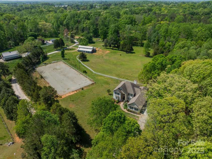 228 Red Dog Drive, Mooresville, NC 28115.  MLS# CAR4245955, YatesRealty ID 12253. Lush Pastures, 110' x 200' arena, trails & 4-8 Stall barn