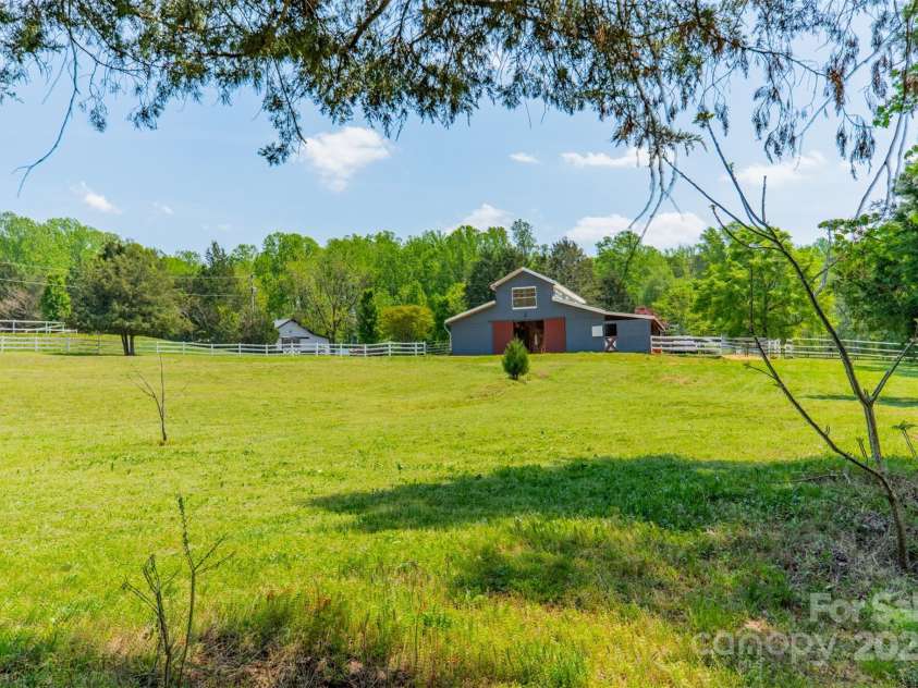 228 Red Dog Drive, Mooresville, NC 28115.  MLS# CAR4245955, YatesRealty ID 12253. Lush pastures with shade trees