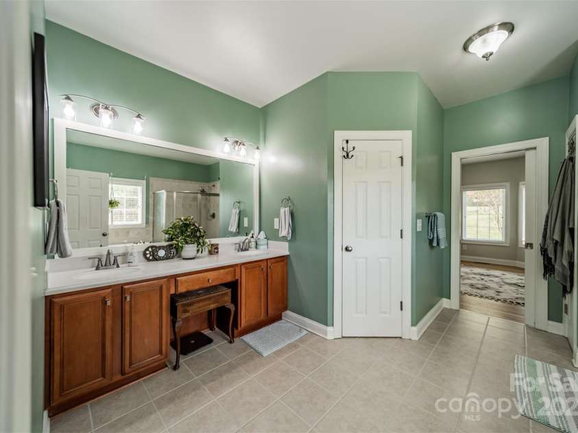 228 Red Dog Drive, Mooresville, NC 28115.  MLS# CAR4245955, YatesRealty ID 12253. Primary bathroom w/dual vanity & make-up vanity, water closet