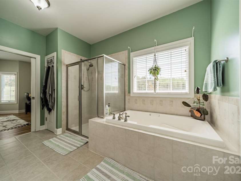 228 Red Dog Drive, Mooresville, NC 28115.  MLS# CAR4245955, YatesRealty ID 12253. Tile and Glass shower, tile surround garden tub