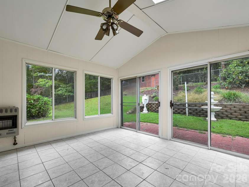 651 Case Cove Road, Candler, NC 28715.  MLS# CAR4335473, YatesRealty ID 12253. Heated Sun Room