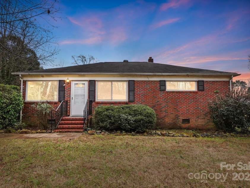 2504 Juniper Drive, Charlotte, NC 28269.  MLS# CAR4209473, YatesRealty ID 12257. Twilight front exterior elevation